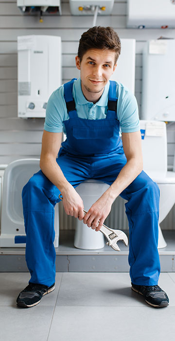 Plumber holding a wrench ready for toiler repair service.